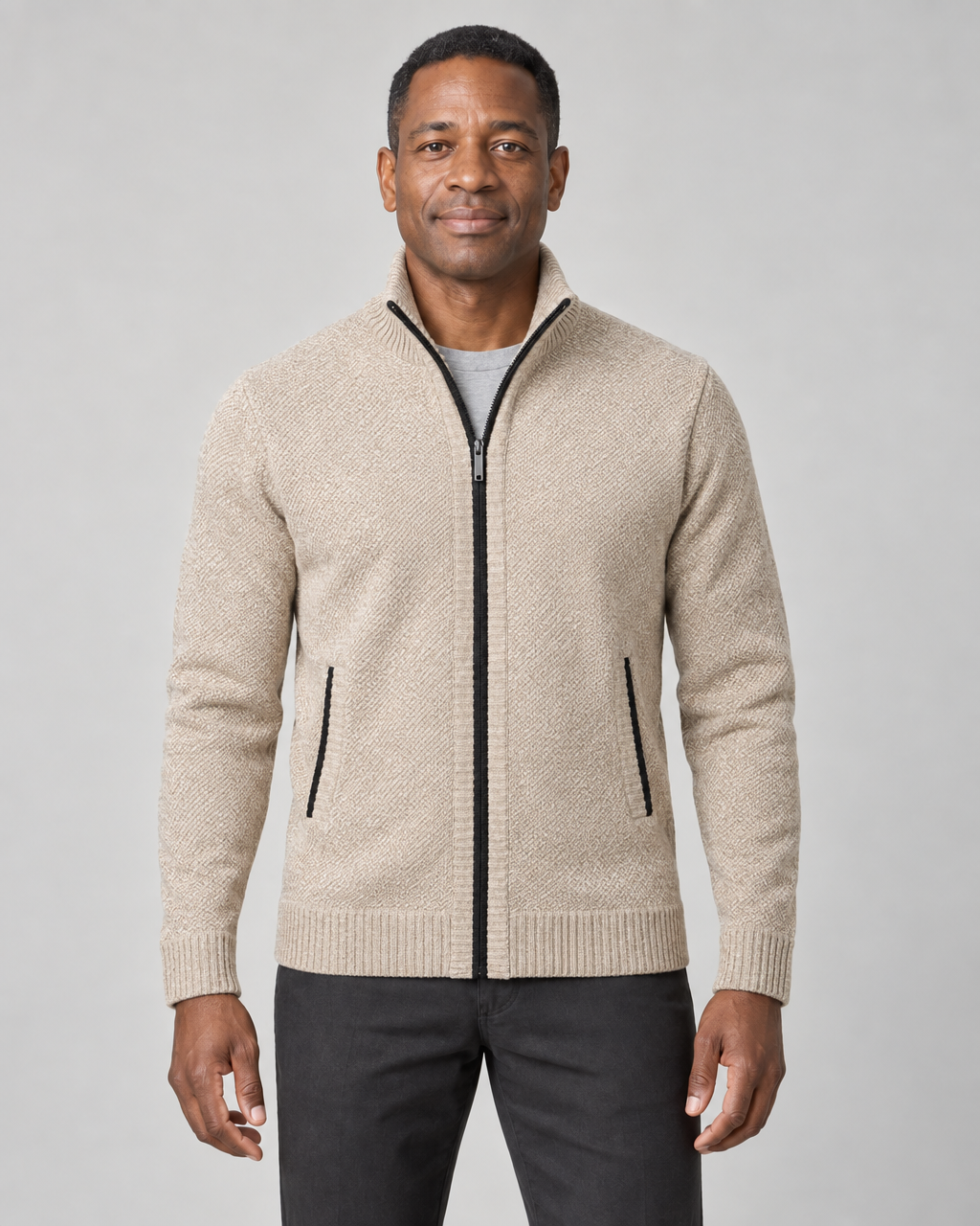 Męski sweter khaki na modelu, widok z przodu; stójka, czarny zamek i dwie kieszenie.
